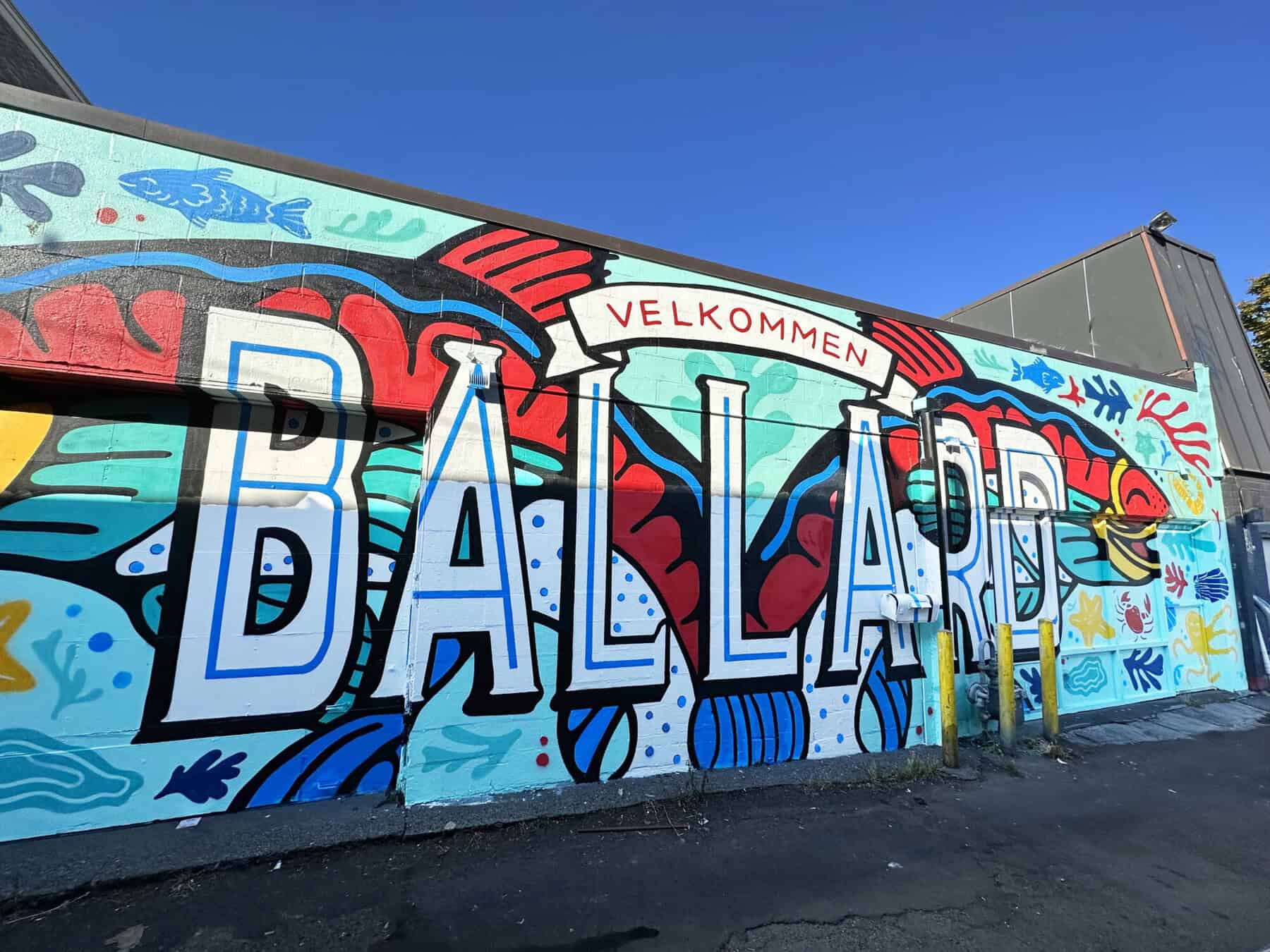 A colorful mural depicting the word "Velkommen Ballard"