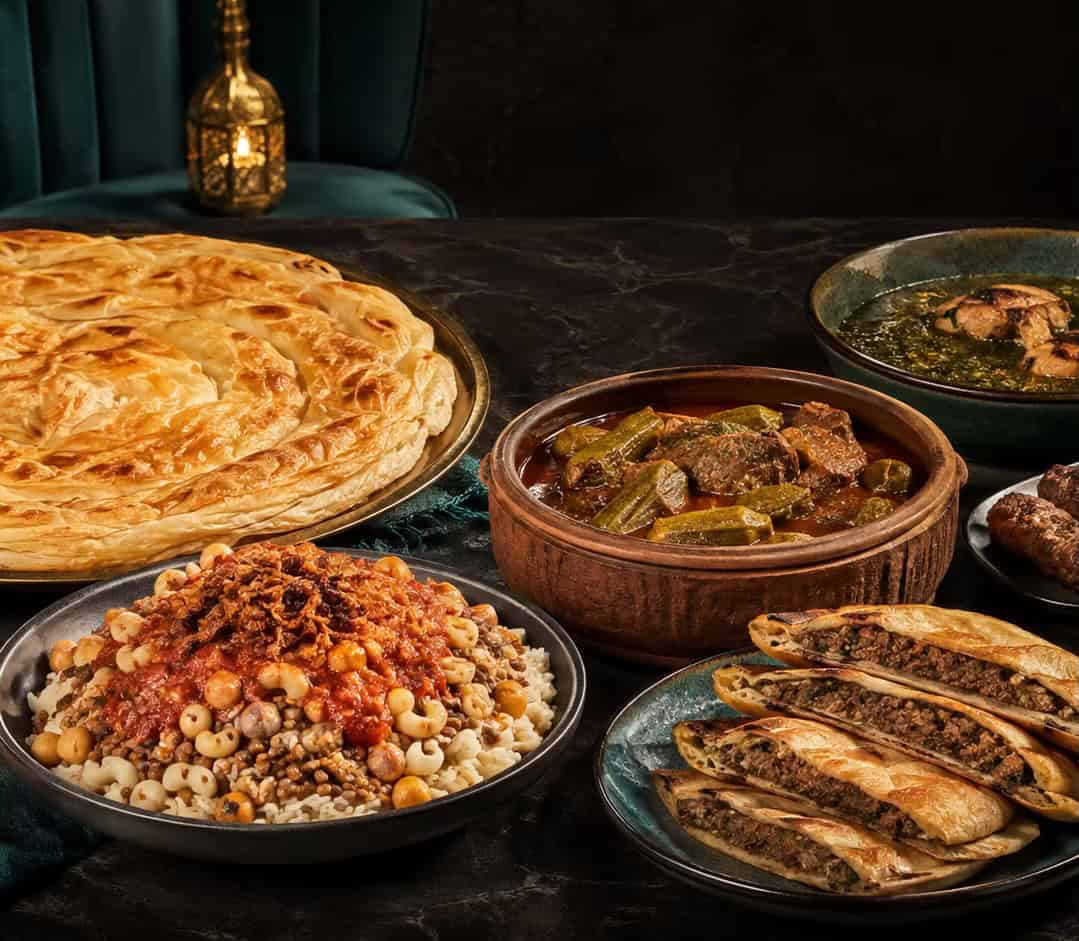A spread of Egyptian dishes including koshari and feteer.
