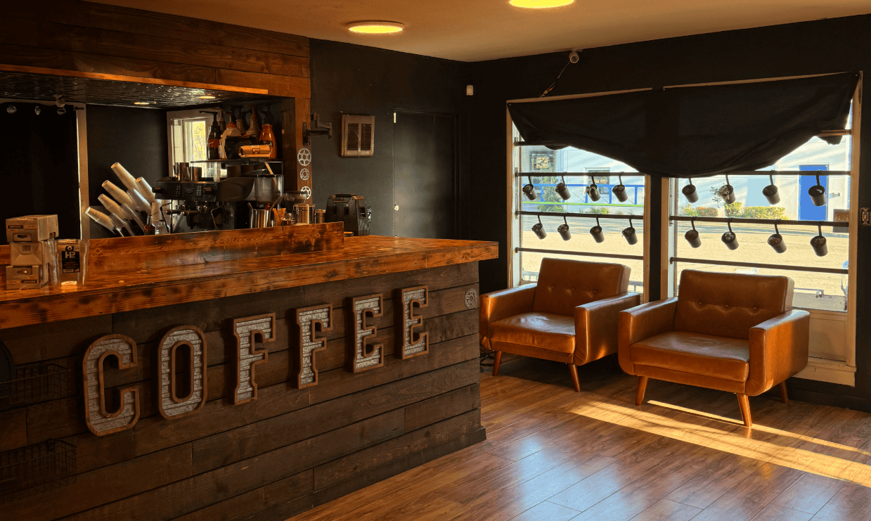 Bright interior of Highland Espresso with cozy seating and large windows.