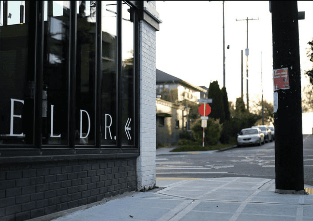 Sidewalk showing restaurant signage.